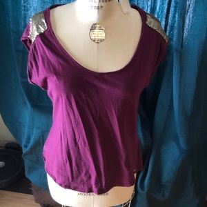 Guess top in good condition with gold metal detail on shoulders.